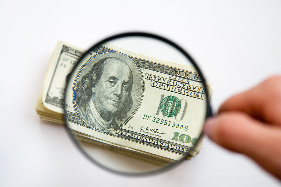 photography of money with magnifying glass