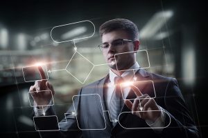 programmer works on a virtual computer screen with a program flowchart demonstrating ERP software implementation