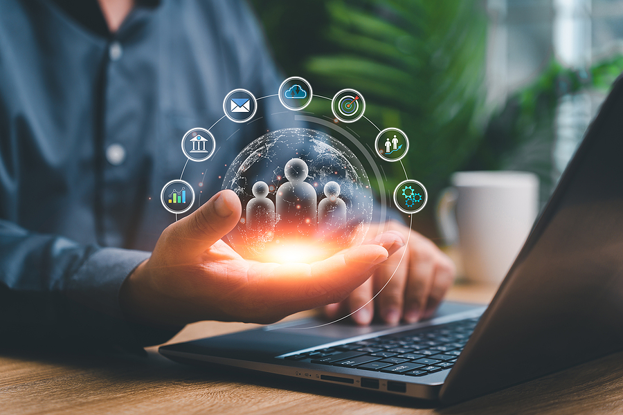 Businesspeople use laptops and hold global network technology, human management development and data social media digital marketing online to demonstrate Sage CRM