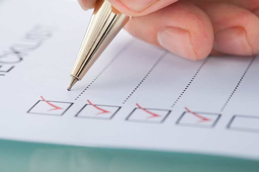 person using a checklist to represent year-end close checklist