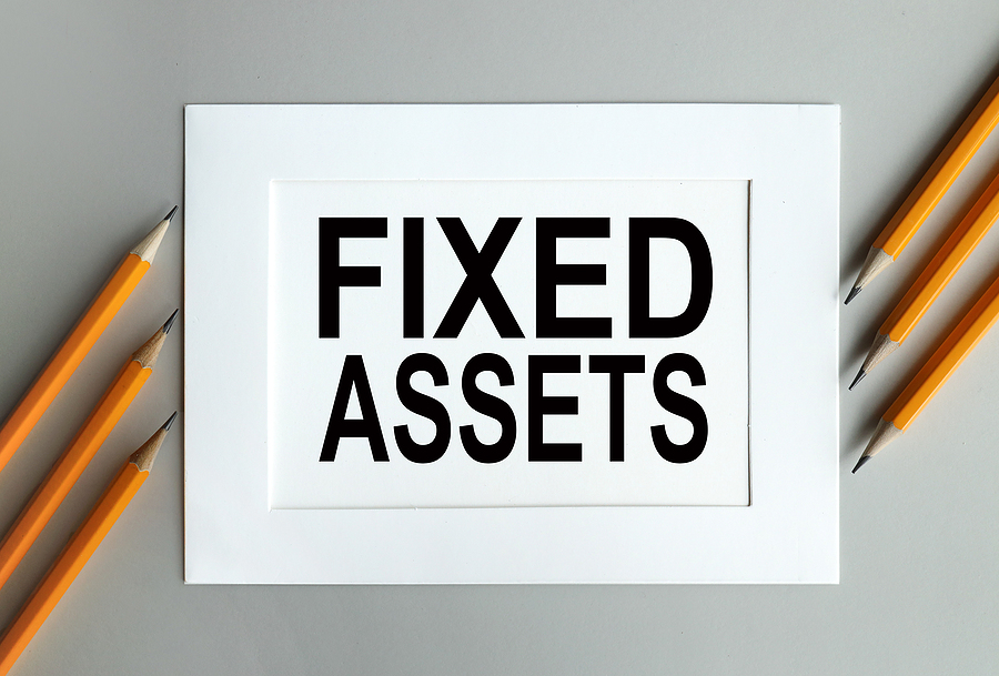 fixed assets. text on white paper in a white frame. on gray background. Sage FAS